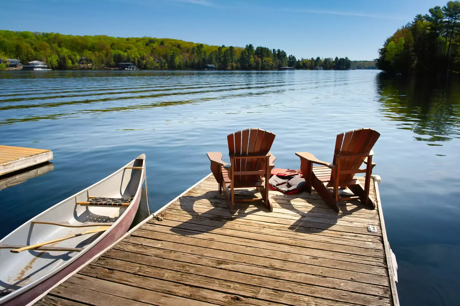 chairs on the dock at a lake